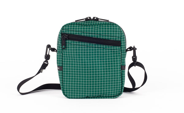 An Everyday Cubelet in Sitka Halcyon (green with a white grid) with a front zipper.